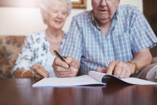 Elder couple making handwritten changes to a will.