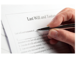 Hand signing a "Last Will and Testament" document