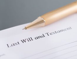 Last Will and Testament" document with a pen
