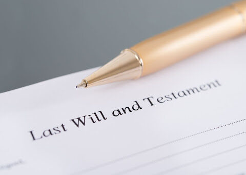 Last Will and Testament" document with a pen