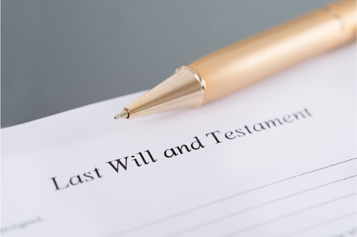 Last Will and Testament" document with a pen