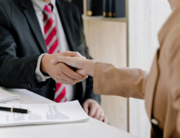A lawyer shaking hands with a client.