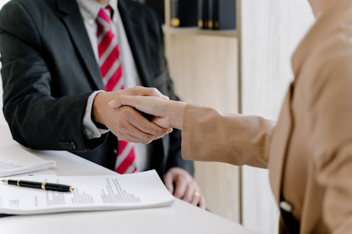 A lawyer shaking hands with a client.
