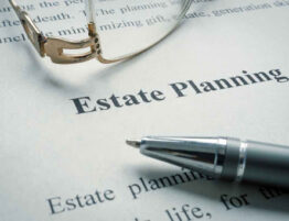 Glasses and pen laid across an estate planning document.