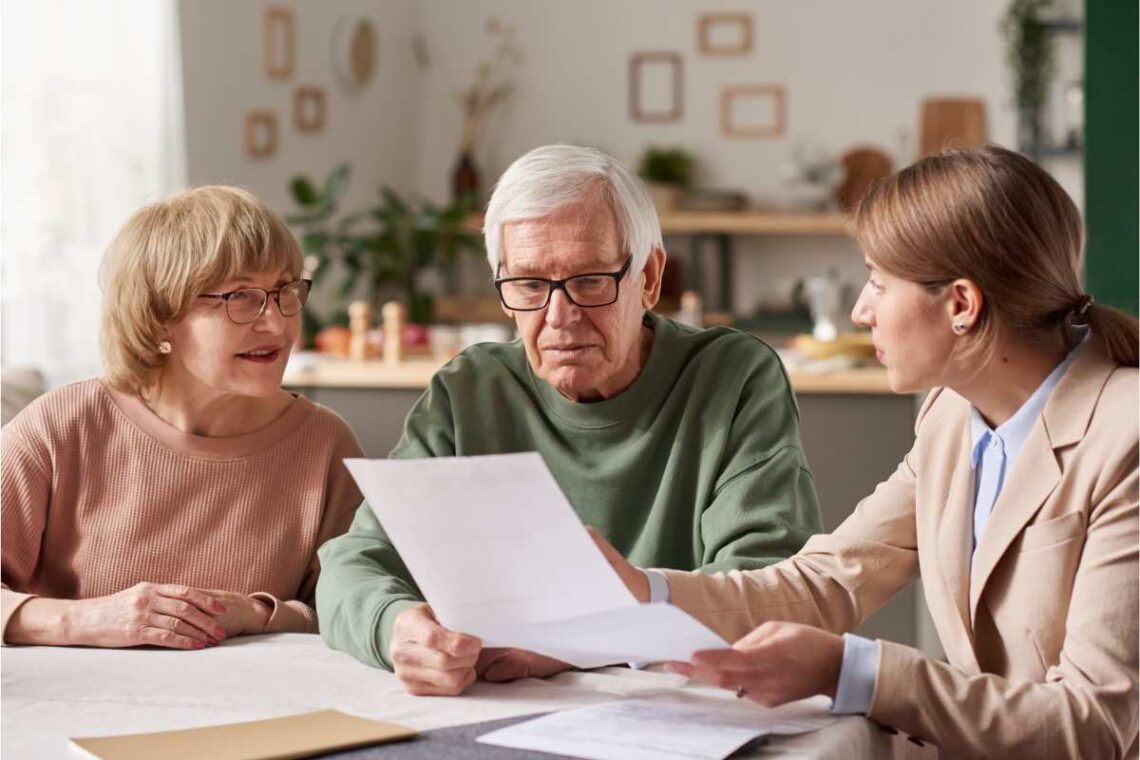 A lawyer talking to a senior couple doling a will