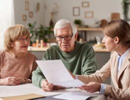 A lawyer talking to a senior couple doling a will
