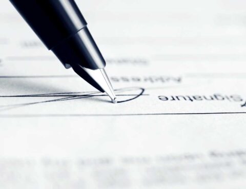 Closeup of a pen signing a will
